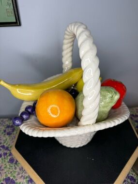 Vintage ceramic basket with fruit and woven basket